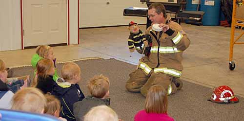 Firefighter teaching children