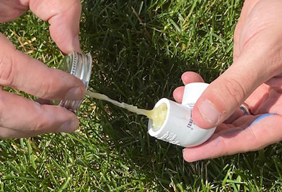 PVC cement is applied to a PVC elbow connector.